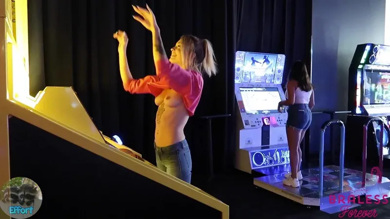 BralessForever goes braless in a public arcade showing her perky tits in this naughty public adventure video